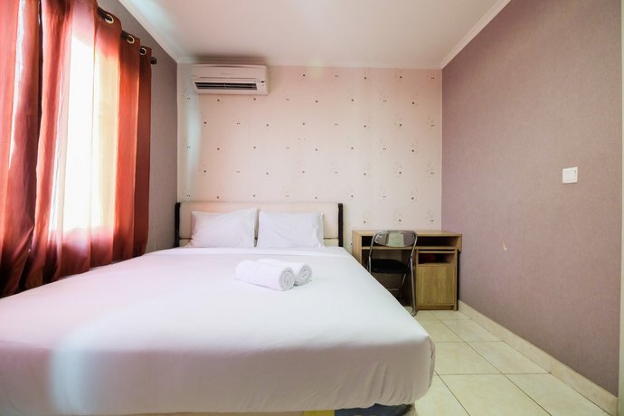 Modern 2BR at City Home Apartment with Sofa Bed near MOI By Travelio